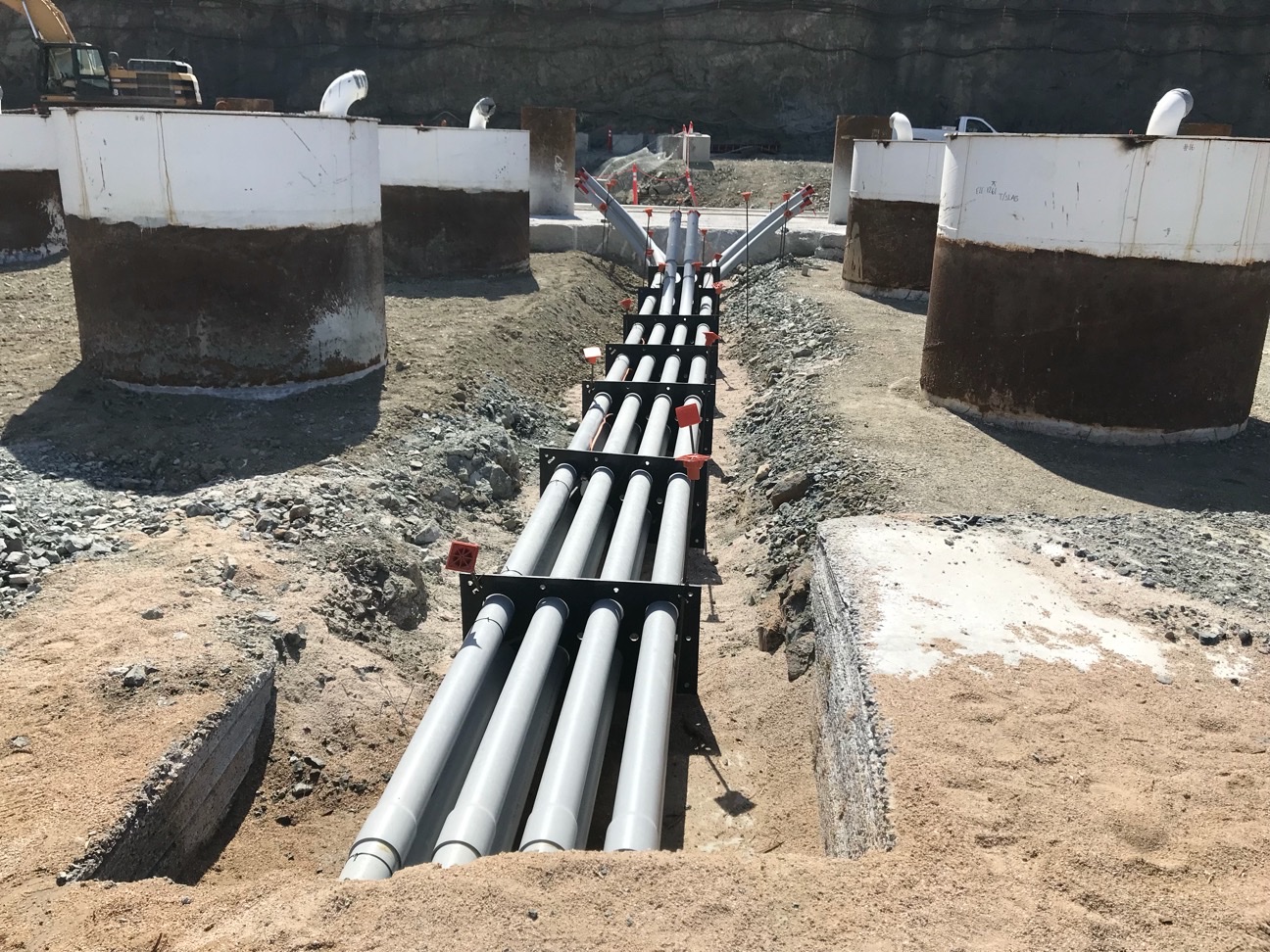 SP Products QwikDuct HDPE templates holding a run of underground conduit in an open trench